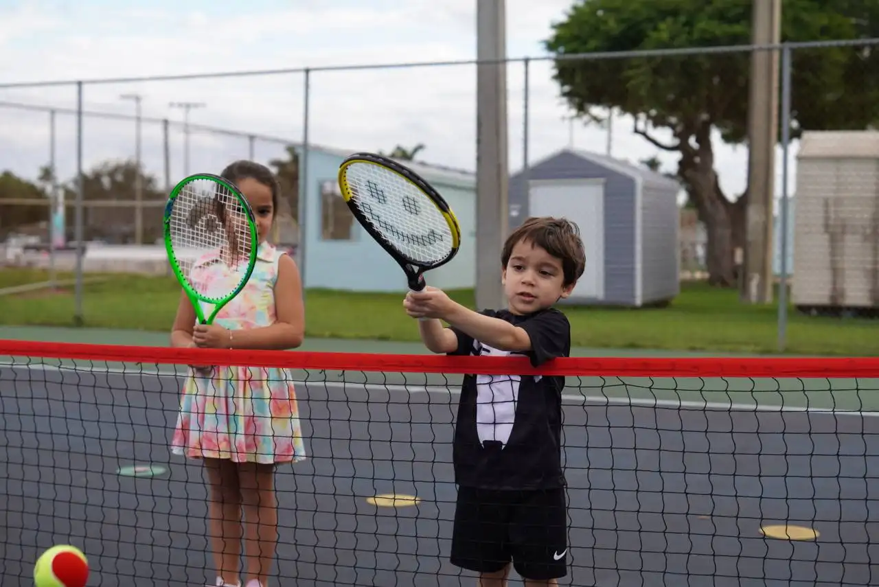 Two children practising at the net
