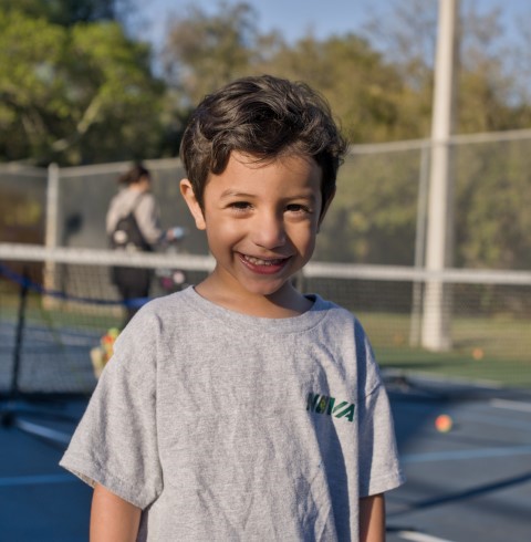Smiling boy in a NOVA T-shirt before class